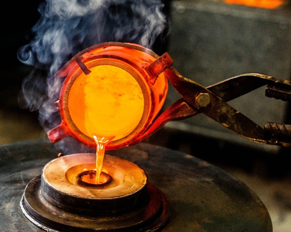 Liquid bronze is poured into the dried and empty casting mould.